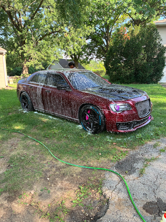 Red Chrysler 300 exterior hand wash with thick soap suds