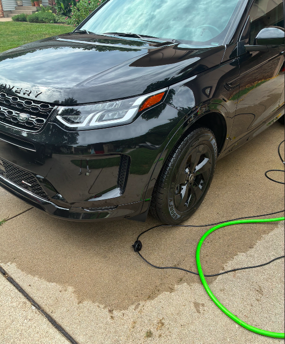 Black Land Rover Discovery with glossy paint and bright headlights